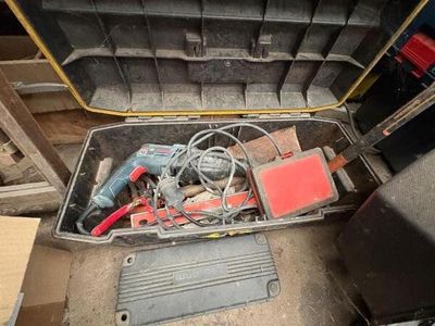 a tool box with tools in it sitting on the floor
