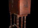 an old wooden box on a stand on a black background