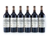 six bottles of red wine lined up on a white surface