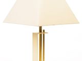 a white lamp with a gold base and a white shade