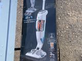someone is standing next to a box with a vacuum on top of it