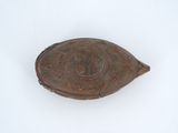 a small wooden object on a white surface