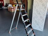 a ladder that is sitting in the middle of a room