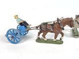 three figurines of people riding in a horse drawn carriage