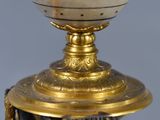 a marble ball on top of a gold plate