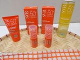 some bottles of sunscreen and lotion sitting on top of a basket
