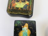 three square plates with a painting on them on a table