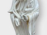 a statue of a woman holding a bird on her arm