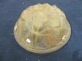 a glass cake pan with a yellow frosting on it
