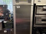 a silver refrigerator and some other appliances in a room