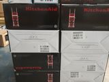 several boxes of kitchenaids stacked on top of each other in a warehouse