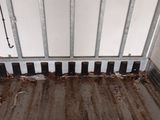 a dirty floor in a dirty room with a radiator