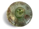 a green glass bowl with a design on it