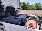 a white truck with a red canister in the back