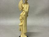 ivory figurine of a woman holding a fan and a fan