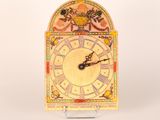 a clock that is sitting on a stand on a table