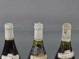 three bottles of wine sitting on top of a table next to each other