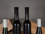 three bottles of wine sitting on a table next to each other
