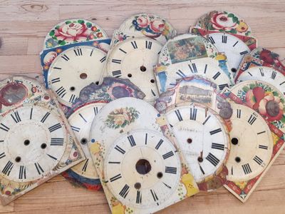 many different types of clock faces on the floor