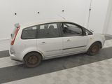 a picture of a small white car parked in a garage