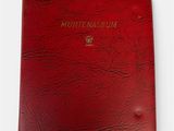 a red book with a gold logo on the cover