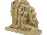 sculpture of a group of people in a circle on a wooden base