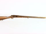an old rifle on a white surface with a white background