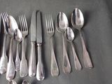 a lot of silver spoons and forks on the table