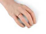 an image of a woman ' s hand with a gold ring on it