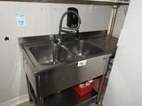a stainless steel sink with a faucet in the corner
