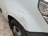 a white truck that has been damaged and is parked