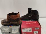 two pairs of men ' s work boots sitting on top of a box