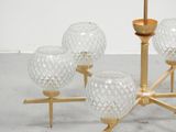 a chandelier made of glass and gold colored metal