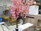 a vase with pink flowers in it on a table