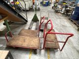 three hand trucks that are sitting in a warehouse
