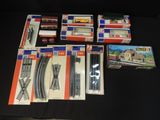 a lot of train tracks and boxes on a table