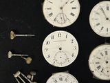 many different types of clocks on a black surface