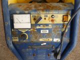 a blue and yellow machine that is sitting on the ground