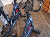 two stationary bikes that are on the floor in the room