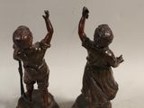 pair of antique bronze figurines of a boy and a girl