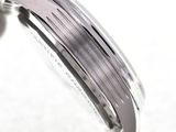 a close up of a person holding a watch in their hand