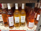 many bottles of wine on the shelf in the store