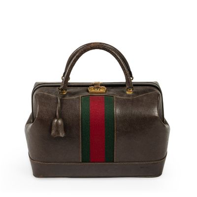 a brown leather handbag with a green and red stripe on the side