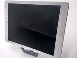 a tablet that is sitting on a stand on a table