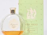 an image of a bottle of perfume sitting next to a box