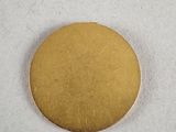 a gold coin sitting on top of a white surface