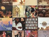 many different album covers on the wall of this room