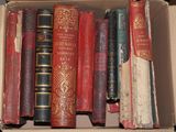 a box full of old books sitting on a table