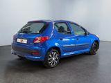 the blue car is parked in a large room with a black floor