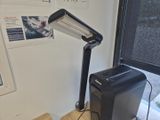 a lamp that is sitting on a desk next to a printer